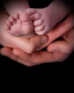 Baby Feet in Adult Hands
